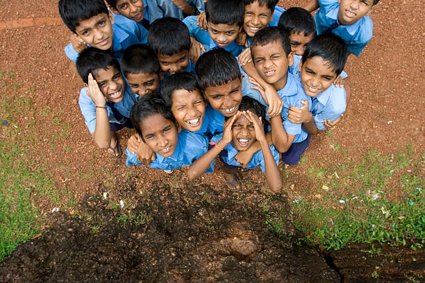 Canacona, Goa, India - September 19,2008: Unidentified Indian schoolboys of an elementary school in the rural area of Canacona-Goa pushing very nosy to a photographer, astonished about his caucasian ethnicity.